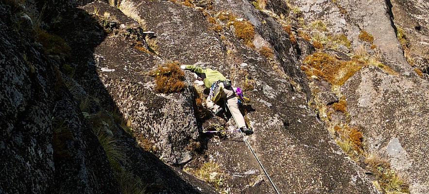Simon starts the Wainui variant route to the right of Bomb Arete